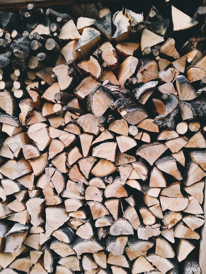 A rustic stack of neatly chopped firewood, ideal for cozy fireplaces and wood-burning stoves.